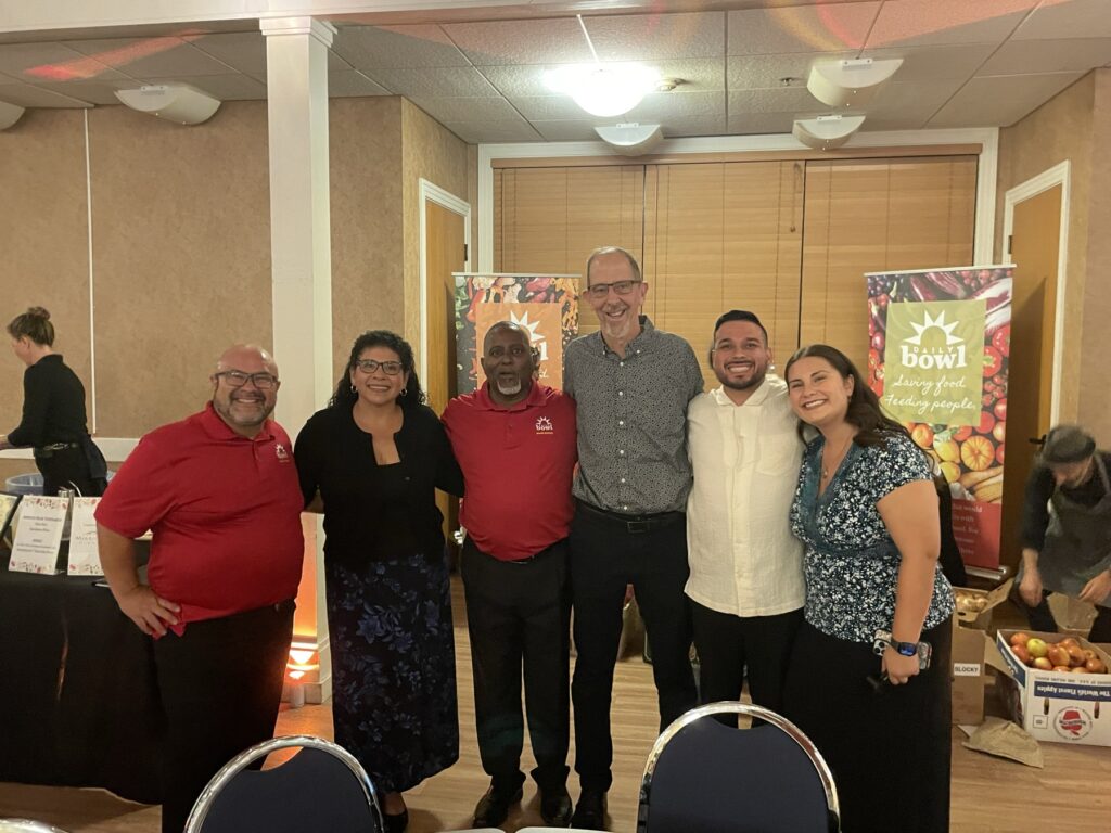 Daily Bowl team and board members together in front of the banners