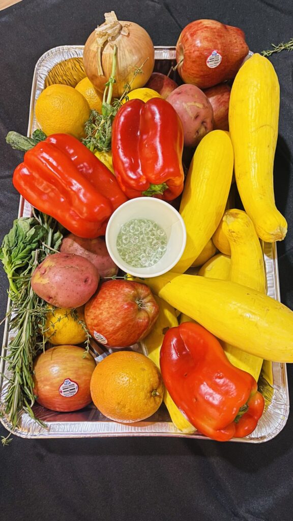 A tray of rescued peppers, squash, citrus and pomegranates
