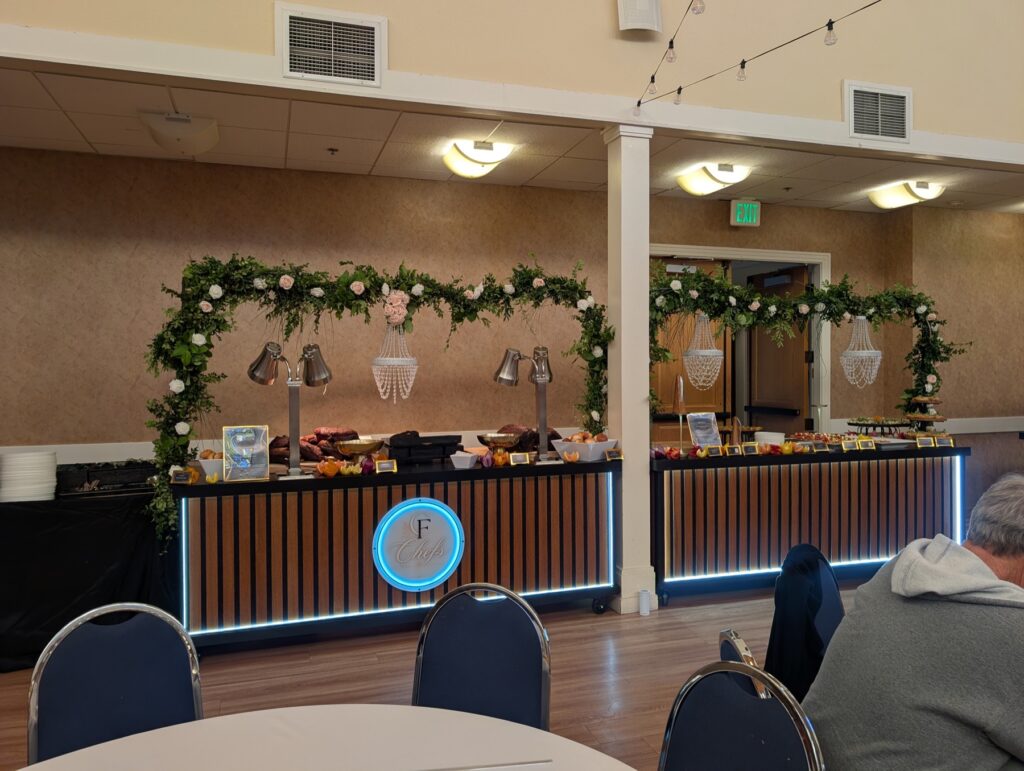 The chef's station beneath a floral arch
